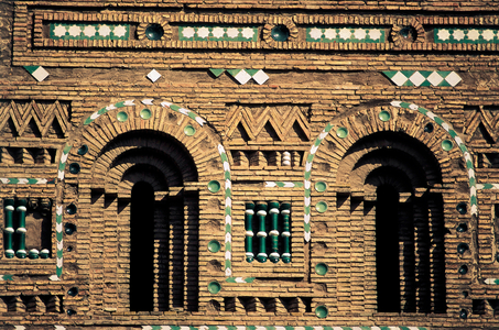 Detail of the bell tower of the church of San Martín, in Teruel, Spain, made of bricks with vitrified tiles that form geometric designs and false arches, Mudejar architecture, 12th-13th century (photo)