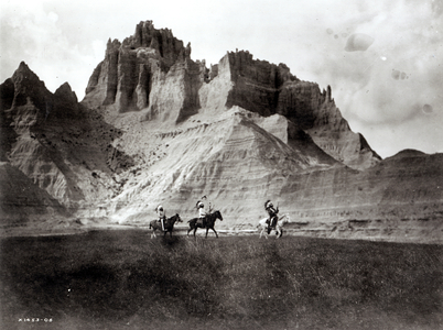 Entering the bad lands, three Sioux Indians on horseback, c.1905 (b/w photo)