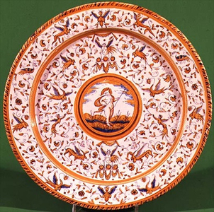 Dish, tin-glazed earthenware painted in blue, yellow and manganese-purple showing grotesques deriving from Raphael's decorations for the Loggia of the Vatican, Urbino style, Dutch, early 17th century       Staffordshire tin-glazed earthenware dish, early 18th century