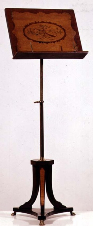 Music stand of satinwood inlaid with harewood. Penwork decoration of musical instruments and lion's paws feet, mid-19th century