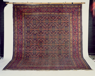 Tabriz Carpet, the indigo field of all over herati design enclosed by madder 'samovar' and leaf borders between multiple guard stripes