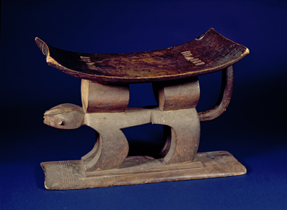 Stool with curved seat supported by a leopard with incised circular posts from the Ashanti tribe of Ghana, Africa (wood)