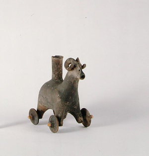 Ritual horned goat vessel, with an elongated neck and hooves formed as wheels, from Amarlu, Gilan, Iran, early 1st millennium BC (clay)