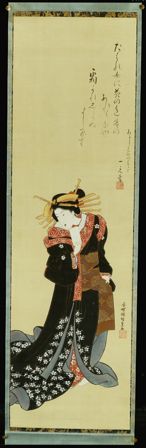 A Standing Courtesan in a Black Kimono with white Flowerheads holding a Wad of Paper (colour, gofun & gold on silk)