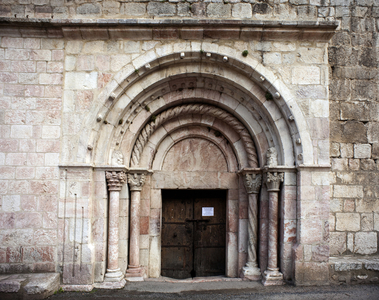 The main door of the church of Saint Jacques (12th century) in Villefranche de Conflent -FRANCE. Occitanie. EASTERN PYRENEES. Villefranche-de-Conflent. Saint-Jacques Parish Church, 11th-13th v. Main gate of the north wall. Romanesque art. Architecture. Photography