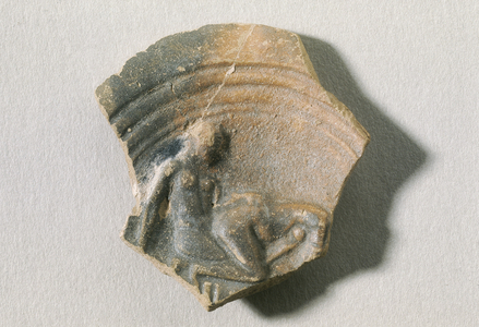 Fragment of voluted roman oil lamp with erotic scene. 1st c. A.D. Roman art Early Empire. Terra-cotta. SPAIN. CATALONIA. BARCELONA. Barcelona. Archaeology Museum of Catalonia. SPAIN. CATALONIA. GERONA. L'Escala. Empurias