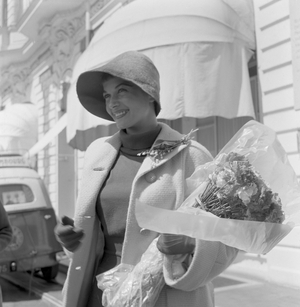 Hungarian actress Eva Bartok holding a bouquet, Lido, Venice, 1955 : With A Bouquet