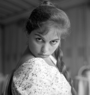 Italian actress Claudia Cardinale, portrayed while wearing a plait and a floral dress, Venice, 1958 : With A Floral Dress