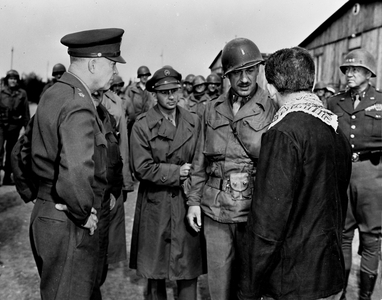 WWII:Ohrdruf Concentration Camp (near Gotha) Germany 12 April 1945: On the left, American General Dwight Eisenhower (Supreme Commander of Allied Forces in Europe) listens to an ex-detenu who tells the camp's living conditions to the interpret officer. On the right, General George S.Patton (CG of the Third US Army). The camp was liberated by the 4th US DB on April 4, 1945