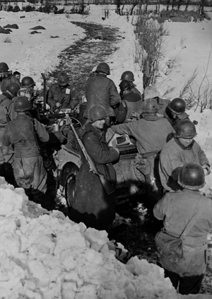 WWII:Near Hofen (Germany) February 1945: Infantrymen from the 9th DI of the 9th US Army surround a Jeep that brings them hot supplies near the first lines