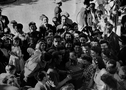 WWII:Paris (France) August 25, 1944: One of the first Americans to return to the French capital, Captain William H. Rice is surrounded by a crowd of Parisians.