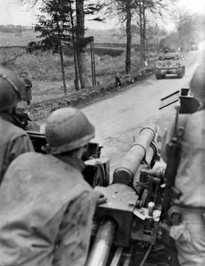 WWII:Battle of the Ardennes (Belgium) around 18-20 December 1944: As a group of Sherman M4 retreated, an M7 armed with an anti-tank gun keeps a strategic crossroads during the German counter-offensive on 16 December 1944