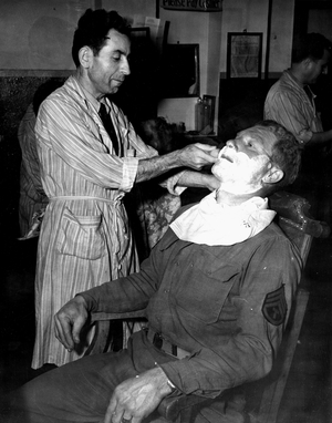 WWII:Marseille Bouches du Rhone (France) June 19, 1945: Awaiting his transfer to the Pacific theatre of operations and during a 24-hour leave, this US Army sergeant is shaved by a barber at the Red Club Center