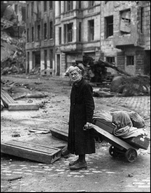 Second World War (1939-1945): an old woman pulling her meagre goods in a street off Cologne after the capture of the city by elements of the 1st US Army. Photograph taken about March 7, 1945.