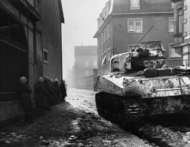 WWII:Colmar (Alsace) France 2 February 1945: During the fighting for the liberation of the Alsatian city, a Sherman M4 tank camouflages the CC4 of the 1st French army supports the advance of the infantry.