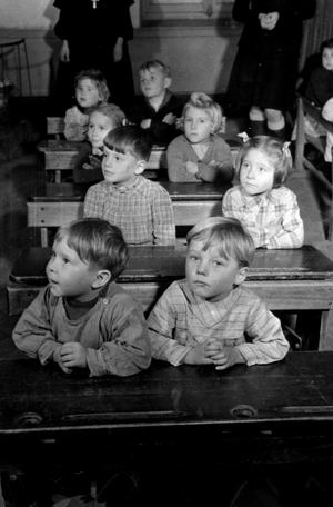 Vouziers (France) October 2, 1944: During the reopening of the school in the city liberated by the Allied troops, first year children listen to their master.
