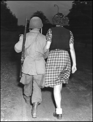 Second World War (1939-1945): Operation Market Garden. An American paratrooper from the 82nd US Airborne Division on the arm of a young Dutch woman who has just been released. Grave, Netherlands, 19 September 1944. Photography.