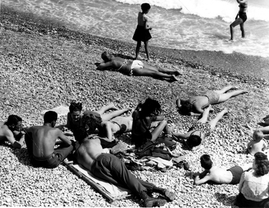 Nice (Alpes Maritimes) France 19 June 1945 These three soldiers of the US Army dependent on the Delta Base Section were granted permission on the French Riviera before being redeployed to the Pacific - Here, on Beaurivage beach, they chat with young Nicoans - After a sea bath, they go up from Beaurivage beach with their girlfriends of american military nurses