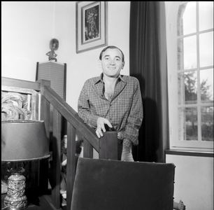 Charles Aznavour in his house in Galluis, France, 1961 (b/w photo)