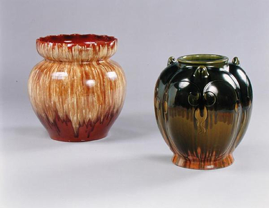 Massive drip-glaze jardiniere in cream and brown glazes, 1879-89, and a massive 'hanging' vase with olive green and orange glazes, 1879-82, both Linthorpe Art Pottery (ceramic)