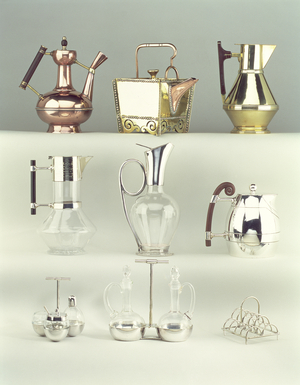 Top, L-R: Oriental Coffee Pot, Benham & Froud, c.1888 (brass, copper and wood); Japanese Rivetted Square Teapot, Benham & Froud, c.1888 (copper and brass); Claret Jug, Richard Perry, Son & Co., c.1880 (copper and rosewood); Middle, L-R: Claret Jug, Hukin & Heath, c.1879 (electroplated silver, glass and wood); Claret Jug, James Dixon & Sons, c.1879 (electroplated silver and glass); Water Jug, Elkington & Co., 1885 (electroplated copper with walnut wood); Bottom, L-R: Three part Cruet and Stand, Elkington & Co., c.1878 (electroplate and glass); Oil and Vinegar Bottles and Stand, Elkington & Co., c.1878 (electroplated silver and glass); Scalloped Toast Rack, James Dixon & Sons, c.1880 (electroplated silver)