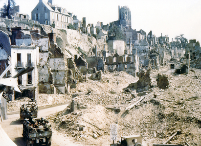 Two United States Army trucks and two American jeeps driving through the ruins of Saint-Lo, August 1944 (photo)