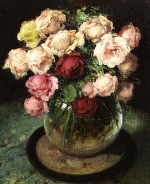 Roses in a glass vase on a table