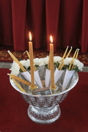 Bussy-Saint-Georges, Ile-de-France, France, le 1/2/2015 - White flowers and candles. Buddhist offerings. Wat Velouvanaram Buddhist monastery.