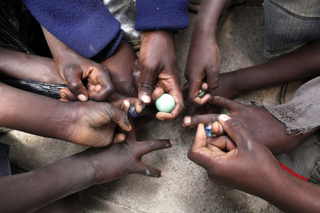 Children playing marbles Nairobi Kenya