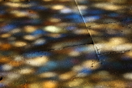 Notre Dame d'Orcival basilica, Orcival, France. Stained glass light on the floor.