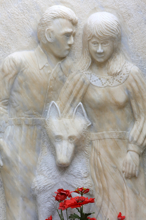 Sculpture of a couple and a wolf on a tombstone, Paris, France