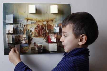 Boy opening an Advent calendar Montrouge France