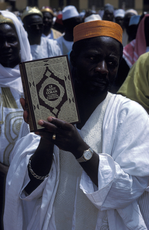 Man holding the Kuran on Eid (End of Ramadan), Foumban, Cameroun