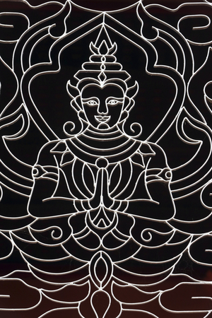 20151028, Vientiane, Laos : Wat Ong Teu buddhist temple. A Goddess decorates a window