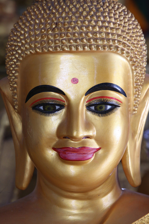 Close-up of a pink-lipped Buddha statue. Cambodia