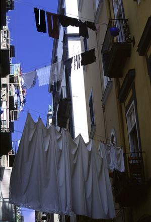 View of a Neapolitan street with linen hanging from the windows.