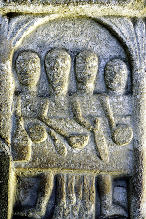 Feasting, detail from the Norman font depicting the labour of the month for December (carved stone)