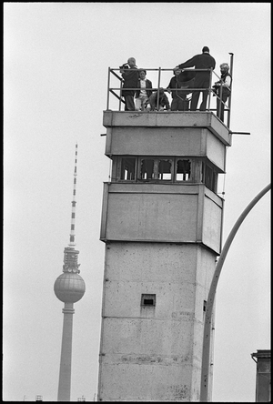 Visitors standing on a watchtower at the former Nordbahnhof, following the fall of the Berlin Wall, June 1990 (b/w photo)