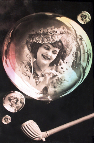 A dream of a woman with a cat in a soap bubble. photography around 1918