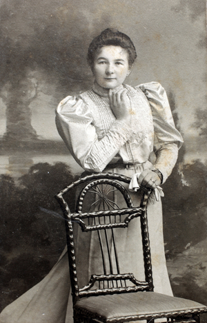 Portrait of a woman sitting in a chair.