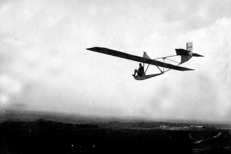 Aviation: Man on a glider in full flight.