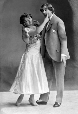 Man and woman pointing each other's cheek.