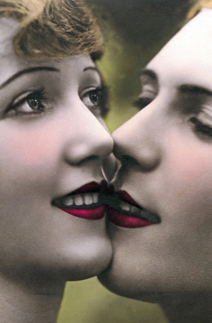 Close-up of faces of women giving each other a kiss on the lips, 1920 (photo)