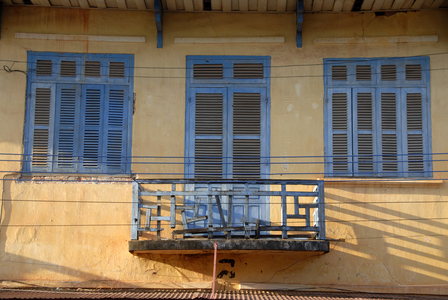 English colonial period facade with small balcony; windows with shutters; Thakhek; Khammuan province; Khammouane; Laos; Southeast Asia; Asia