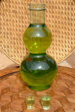 Green Lao Lao; bulbous glass bottle filled with alcohol; Laotian rice liquor; Phongsali; Phongsali province; Laos; Southeast Asia; Asia