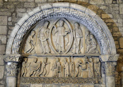 Romanesque art: Cathedrale Notre Dame, La Charite sur Loire (Charite-sur-Loire), Nievre, Burgundy, France. The eardrum of the Transfiguration. Transfiguration of Christ (mandorle) in the oratory gesture, shows a book of teaching surrounded by Moses and Elijah who represent the law and the prophets. The three kneeling apoters of the image of the verb embodies. Lintau lower right Presentation in the temple and Lower left Adoration of the Magi The largest church in Europe after that of the Abbey of Cluny. Photography