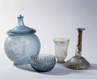 Antique glassware: Orange and Arles glass. Cinerary urn, glass cup, drinking glass, bottle. 2nd - 5th century ap. JC. Mediterranean Archeology Museum, Marseille.