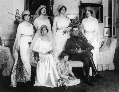 Bride and bridegroom with bridesmaids and train bearers (b/w photo)