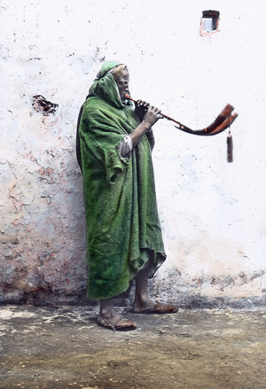 Morocco, horn blower, image date: circa 1910. Carl Simon Archive