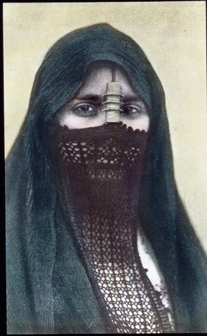 Egypt, portrait a woman with a face veil, image date: circa 1910. Carl Simon Archive